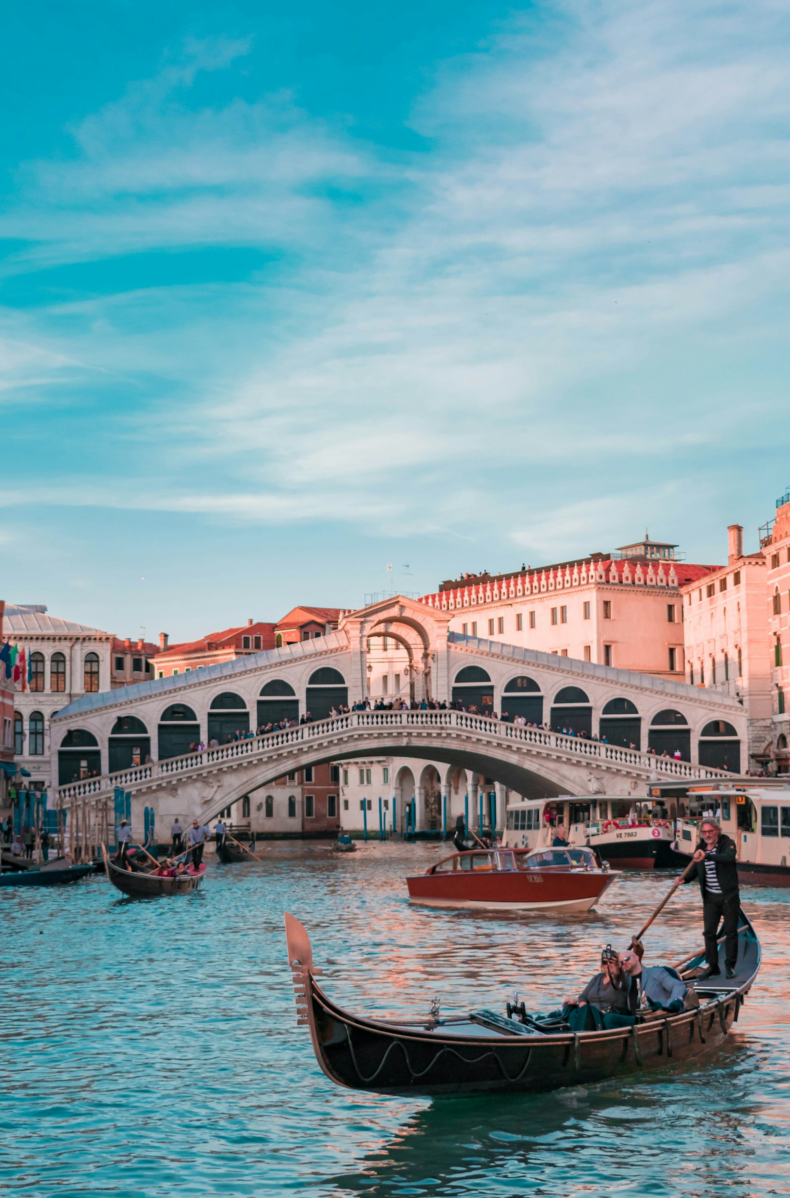 Quiet Venetian canal lined with historic buildings and moored boats