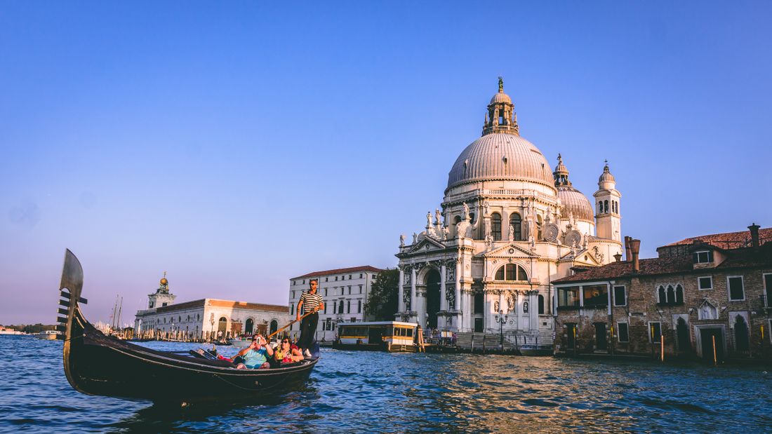 Gondola gliding along a Venice canal beneath historic facades